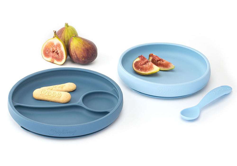 Easy scooping silicone plates with suction in light and dark blue colours. Dark blue plate with dividers and non divided light blue plate.